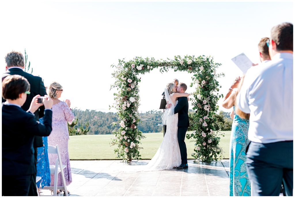 Bride and groom sharing their first kiss as newlyweds at Tehama Golf Club in Carmel, California