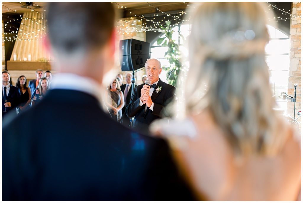 Bride and groom watch as father of the bride gives speech at Tehama wedding