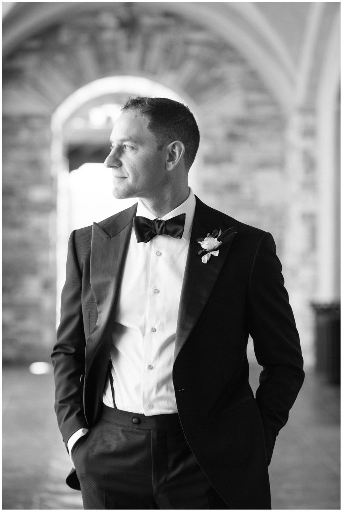 Black and white portrait of groom looking off into the distance