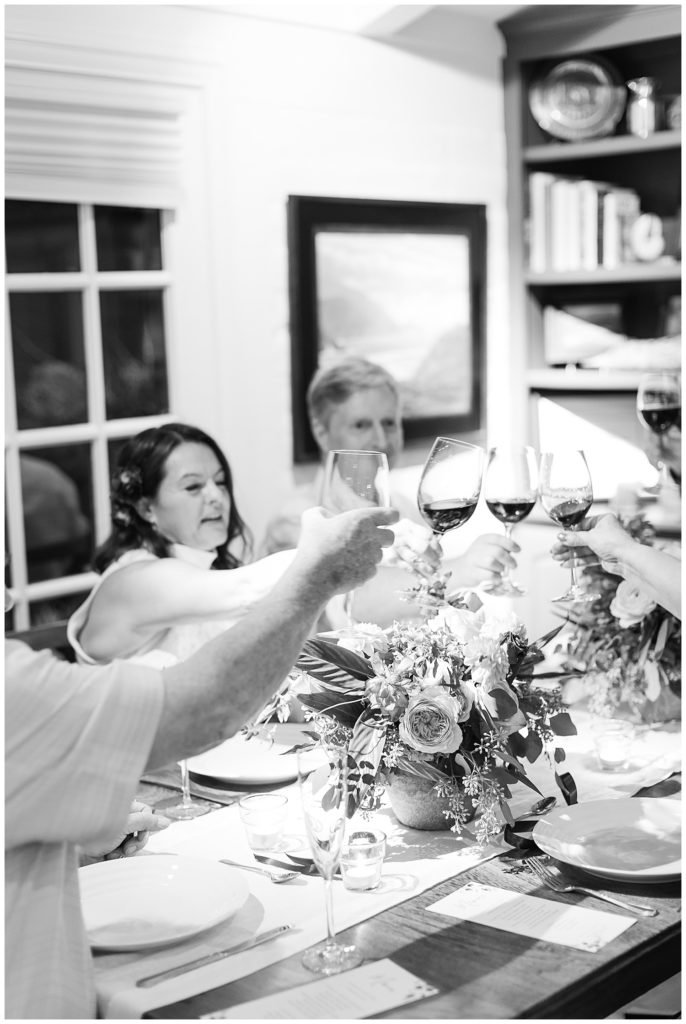 black and white photo of the bride and groom with their guests celebrating their private Carmel estate elopement