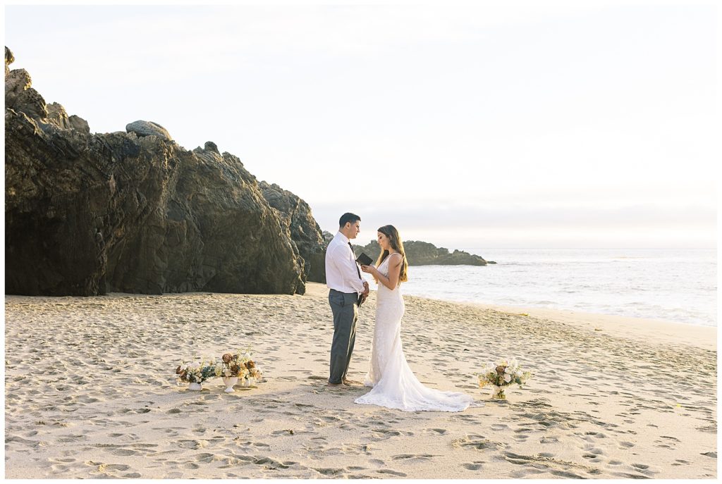 husband and wife renewing their vows at their Big Sur adventure elopement on the sand