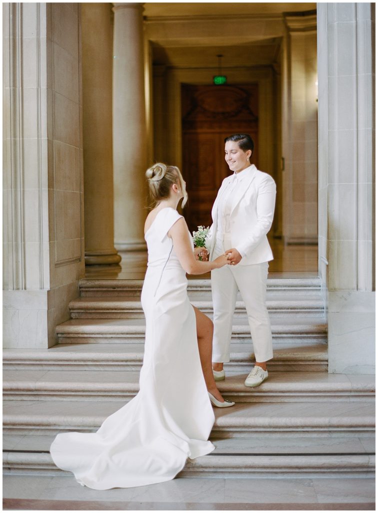 brides greeting each other on the steps at San Francisco City Hall