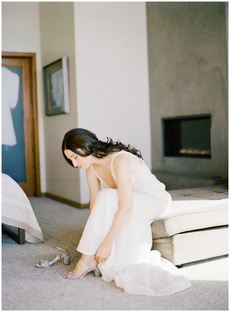 bride getting ready for her Wind & Sea Estate Big Sur wedding and putting on her Badgley Mischka heels