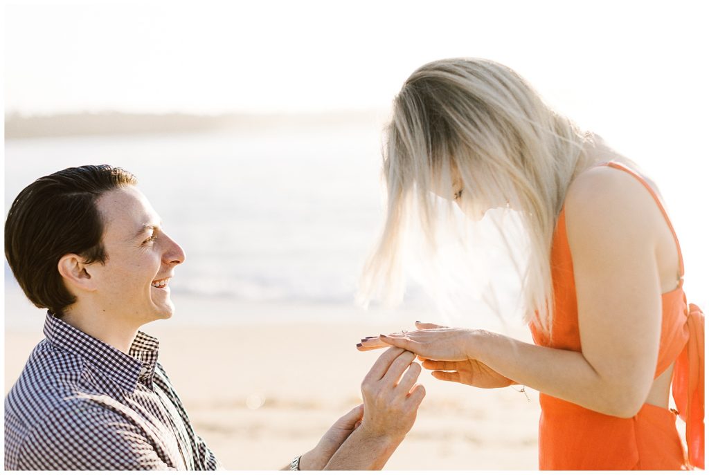 a woman laughing with joy after being proposed to