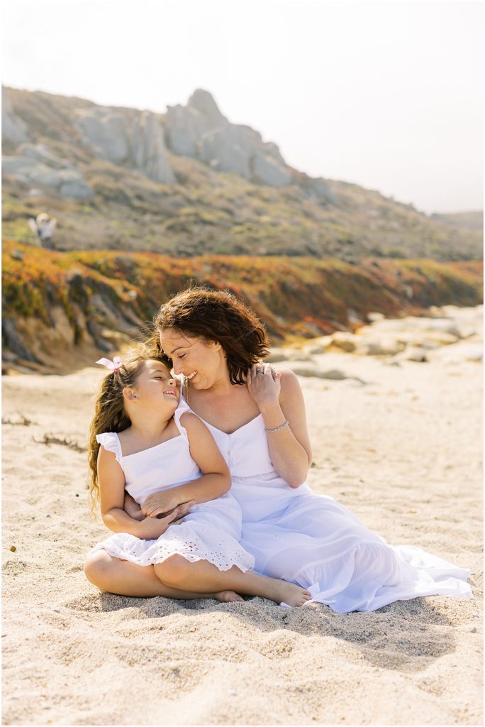 portrait of mother and daughter sitting on beach by film photographer AGS Photo Art