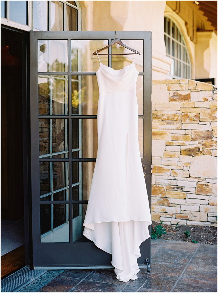 portrait of bridal gown hanging on display by film photographer AGS Photo Art