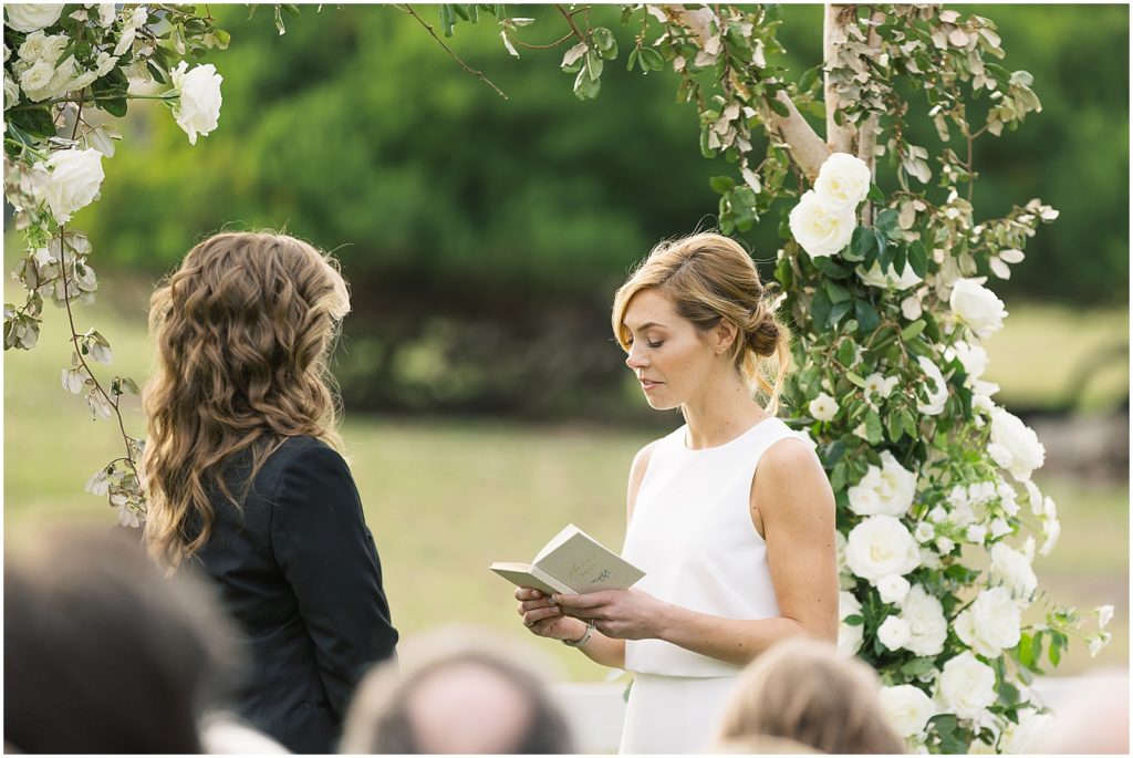 portrait of bride and groom reading vows to each other during ceremony by film photographer AGS Photo Art