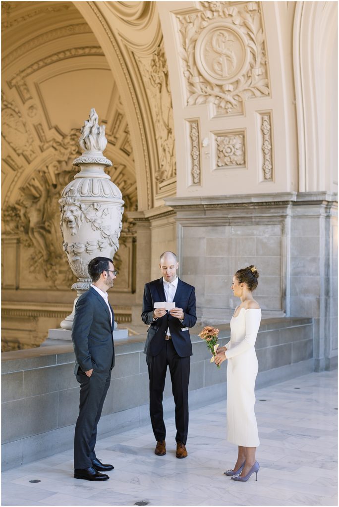 portrait of bride and groom facing each other during ceremony in city hall by film photographer AGS Photo Art