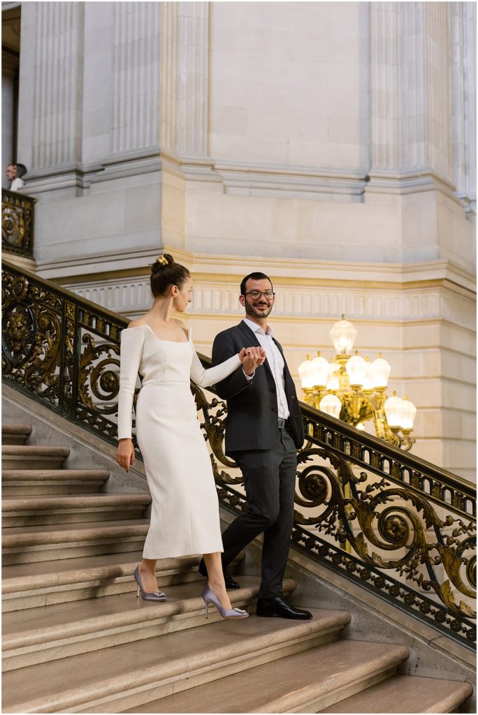 portrait of couple walking down staircase in city hall by film photographer AGS Photo Art