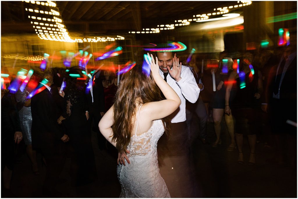 portrait of bride and groom on dance floor with wedding guests during reception by film photographer AGS Photo Art