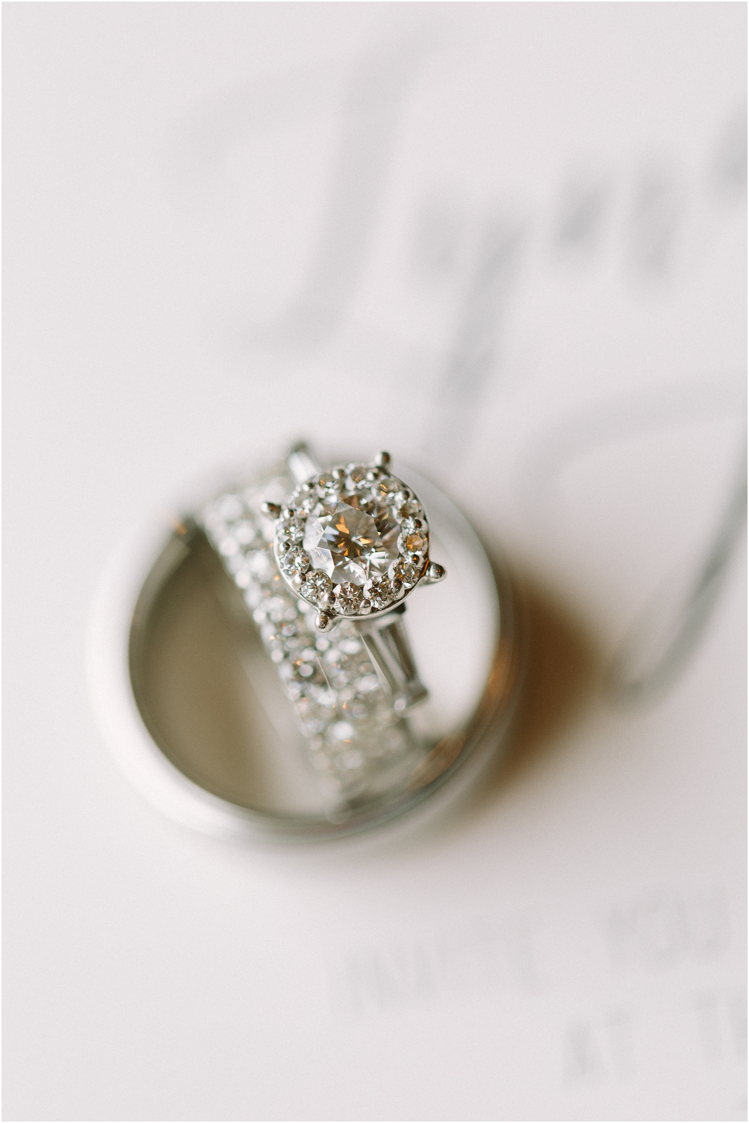 close up shot of diamond ring. Round diamond with halo and double infinity wedding band

