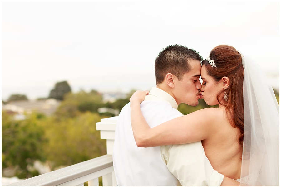 Perry house wedding couple kissing on the deck of venue over looking Monterey Bay photo by ags photo art