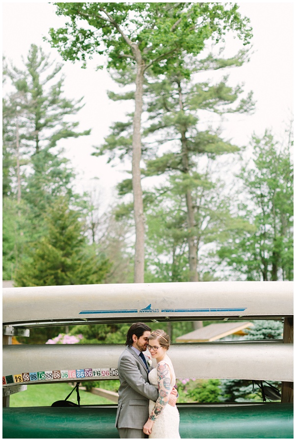 Unique wedding in the Poconos bride with tattoos bride and groom portrait in woods with kayaks 
