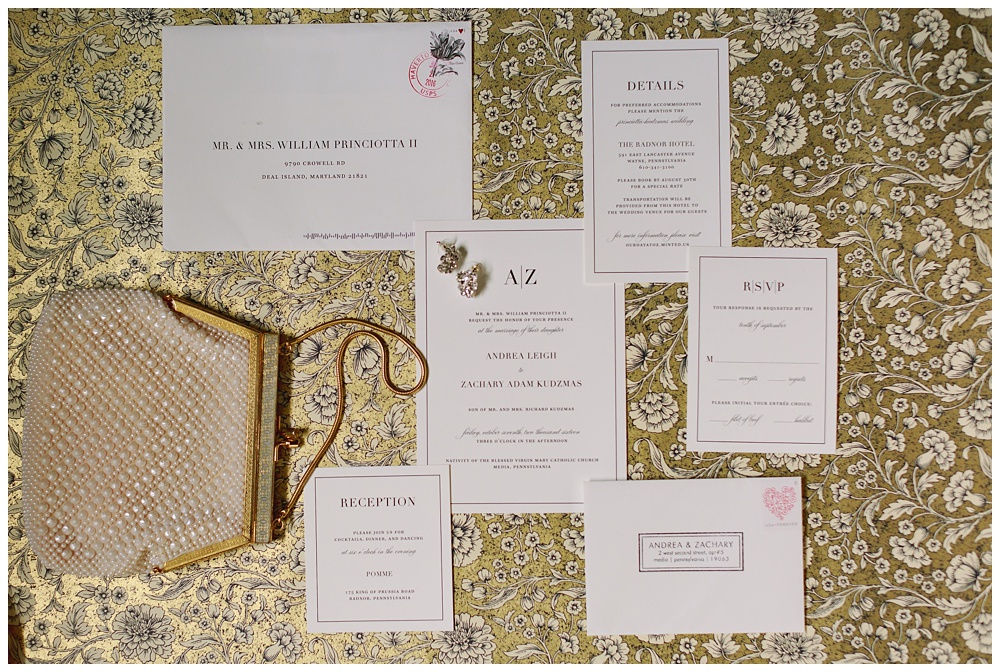 A flatlay of Pomme wedding invitations on gold background by AGS Photo Art