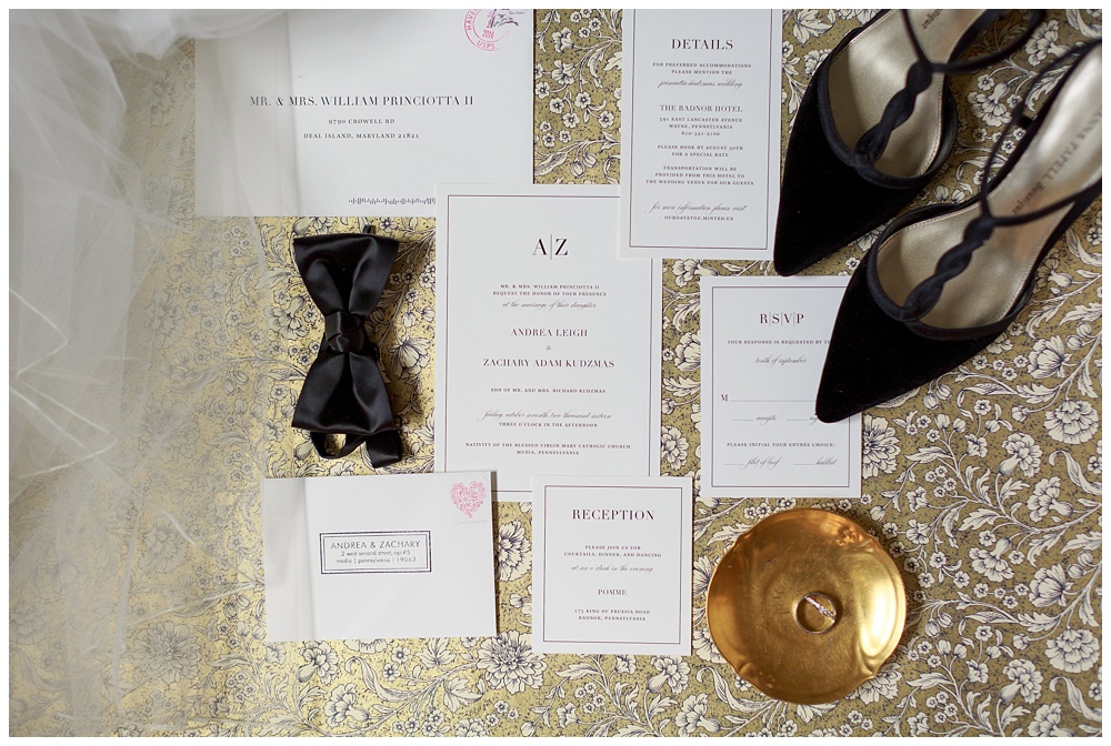Wedding invitations and shoes on gold background at the Pomme in PA