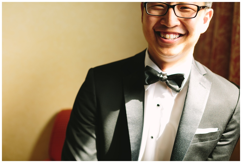 Groom with glasses smiling on his wedding day in Radnor, PA