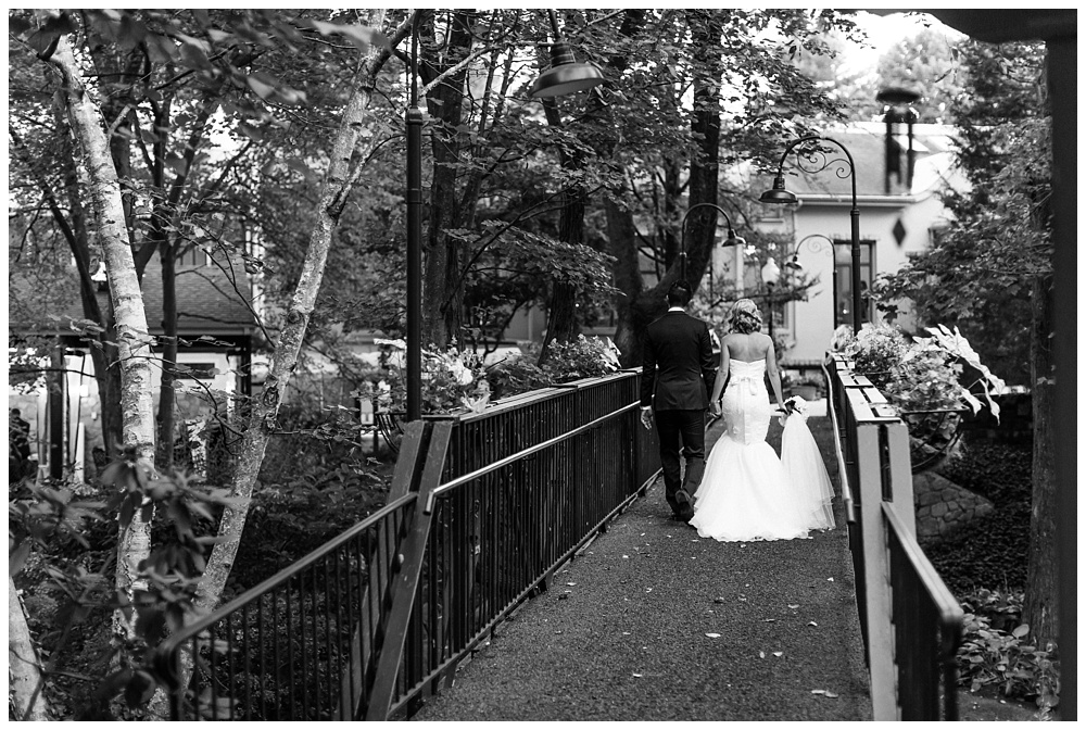 Black and white portrait of bride and groom walking on bride in Radnor PA