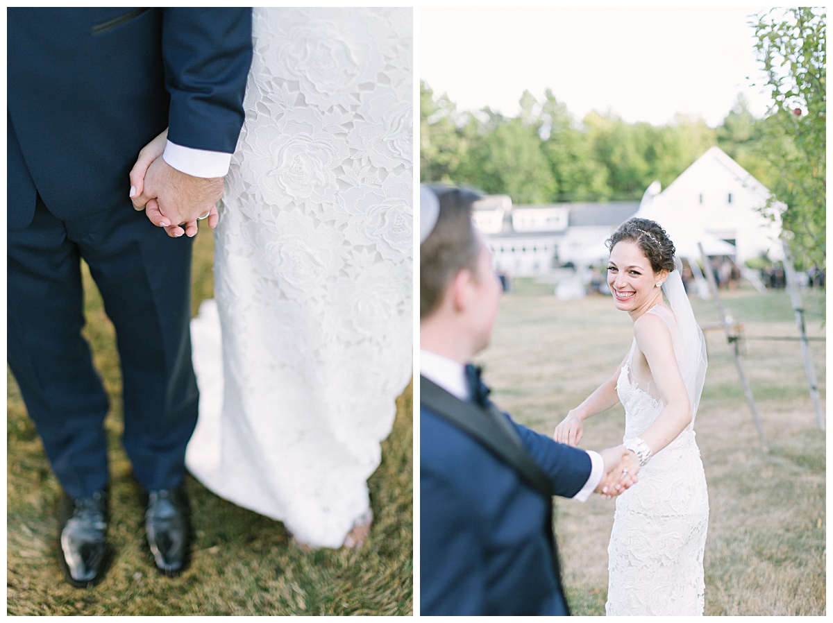 Bride and groom holding hands in front of country barn