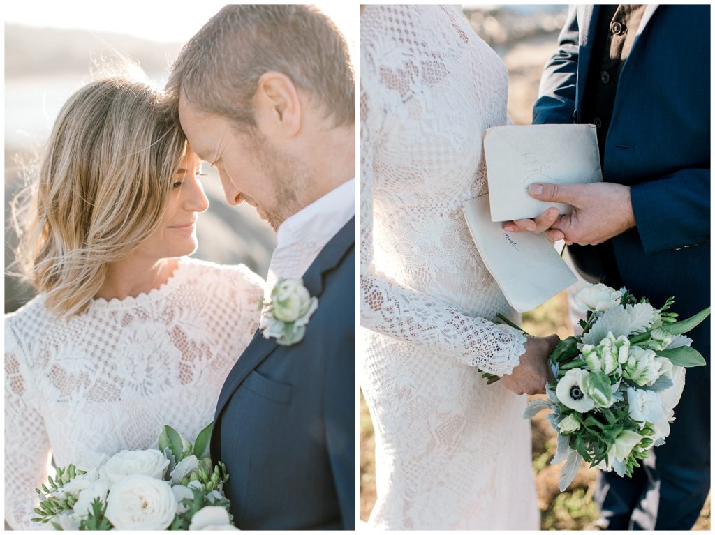 Couple touching their foreheads together while holding their handwritten vows and bouquet of white ranunculus flowers