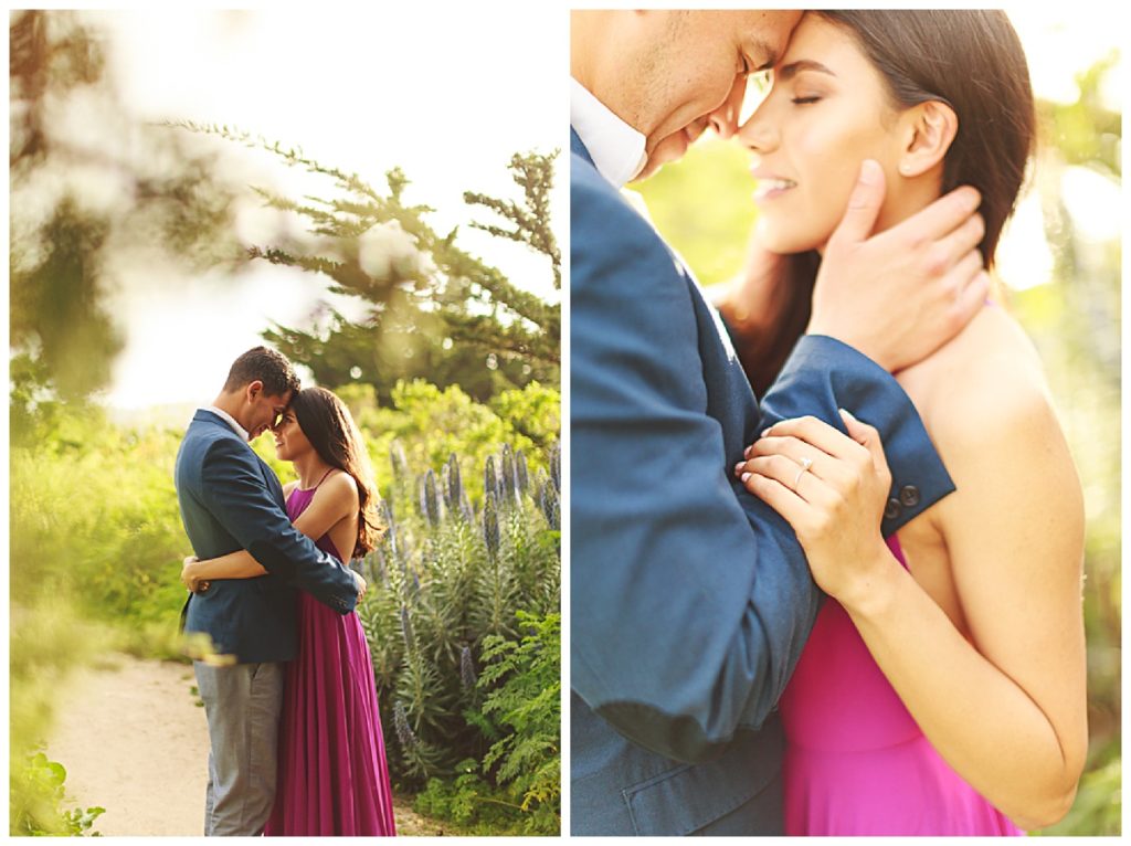 Woman in pink dress and man in blue blazer embrace in Big Sur garden