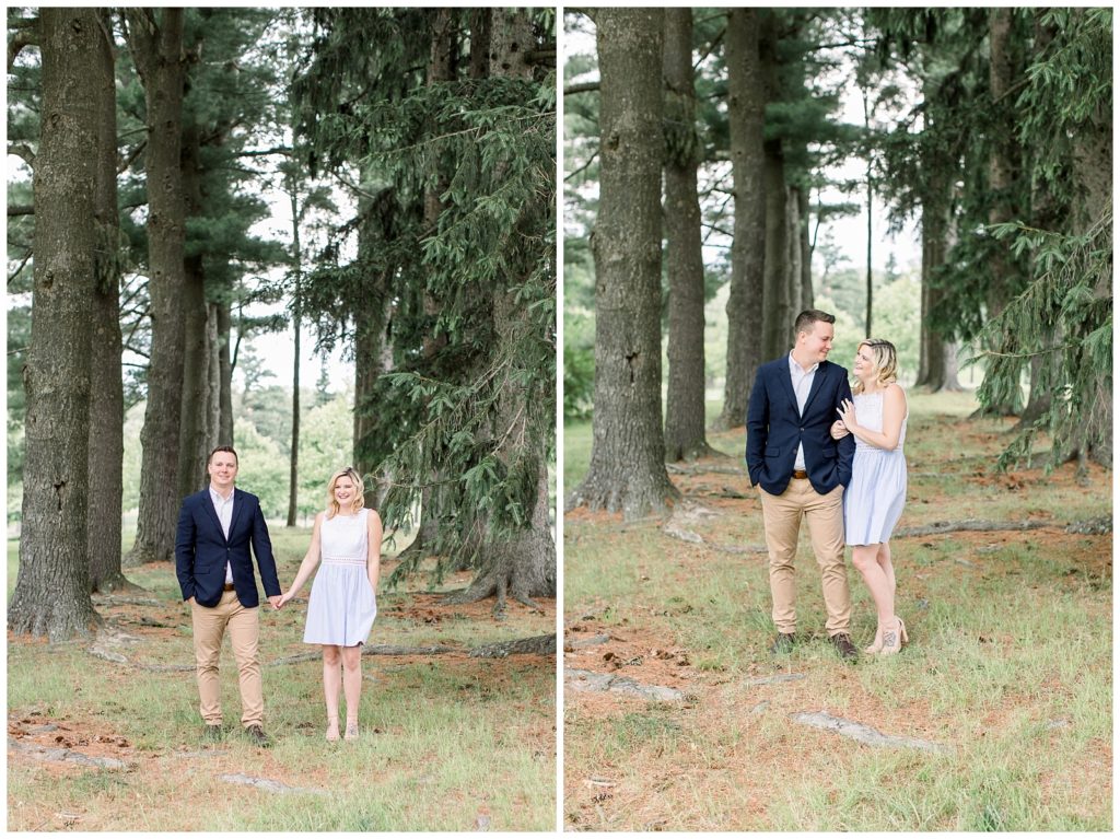 couple hand in hand and arm in arm surrouded by tall trees