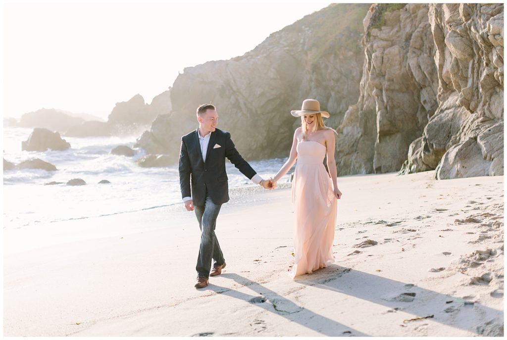 floppy hat couple on beach gown and suit walking down the beach