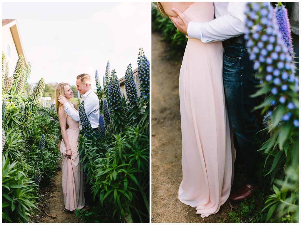 couple dressed in pastel pink dress and navy blue slacks in a garden