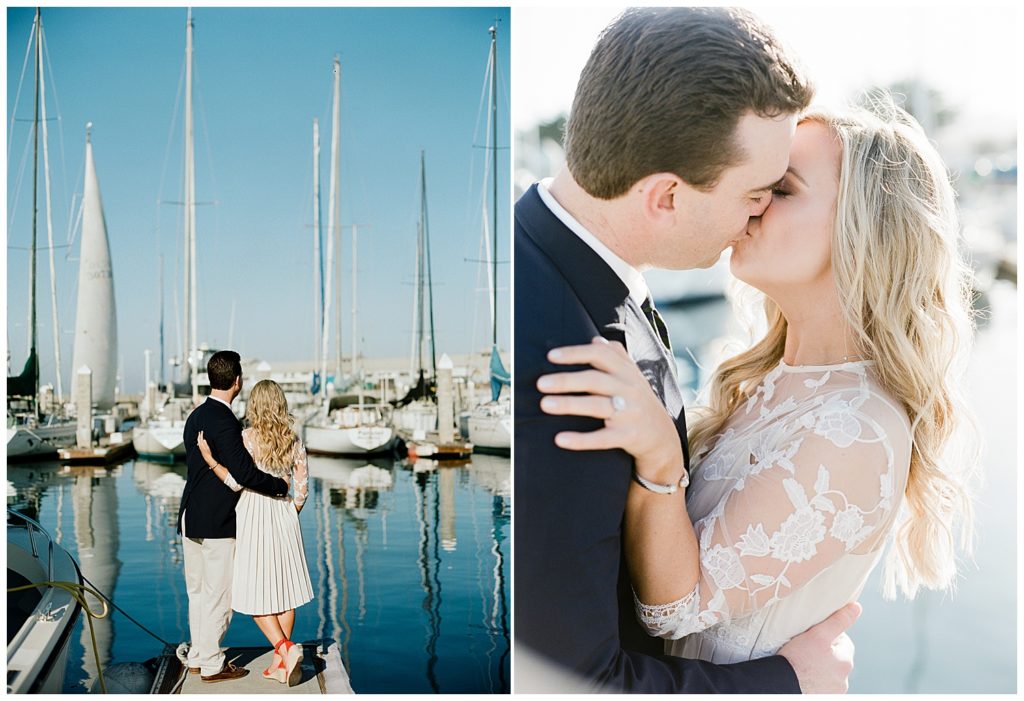 couple looking out at the sailboats on the dock then kissing in Monterey