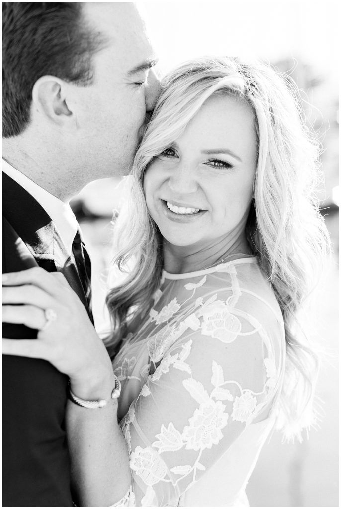 black and white couple portrait with the groom kissing the bride's temple by film photographer AGS Photo Art