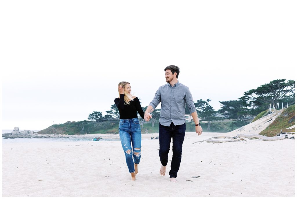 The couple runs and plays on the sands of Carmel Beach during their Powerful And Heartfelt Anniversary Session by film photographer AGS Photo Art