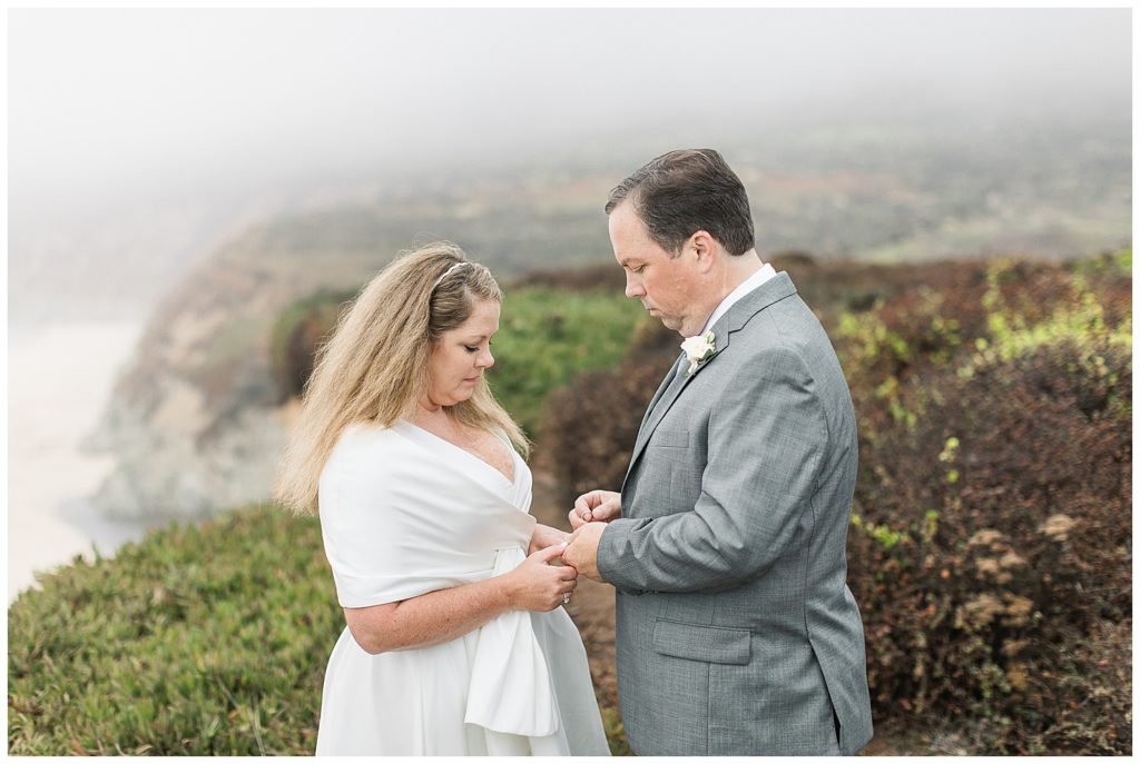 the bride and groom donning their Big Sur elopement wedding rings by film photographer AGS Photo Art