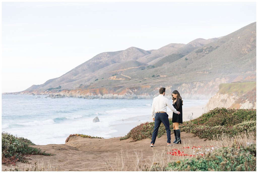landscape photograph of the couple where the man comforts his overjoyed fiancée now that they're engaged