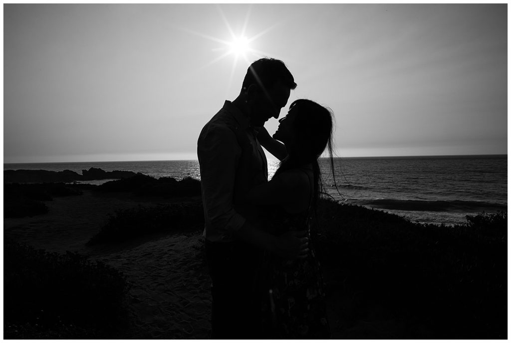 black and white Big Sur Surprise Proposal couple portrait with the sun and ocean behind them by film photographer AGS Photo Art