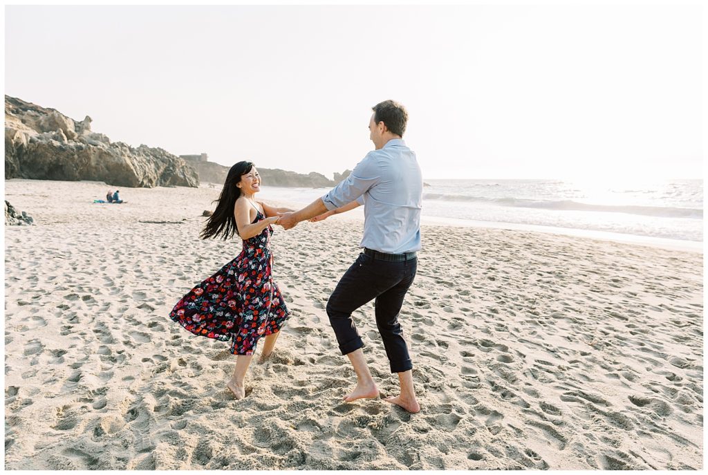 smiling couple dancing at the beach