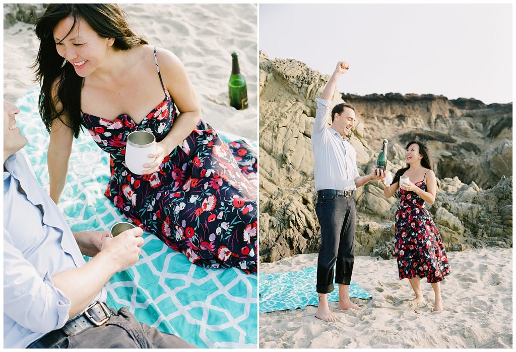 couple celebrating their Big Sur Surprise Proposal with a picnic on the sand and chapmagne