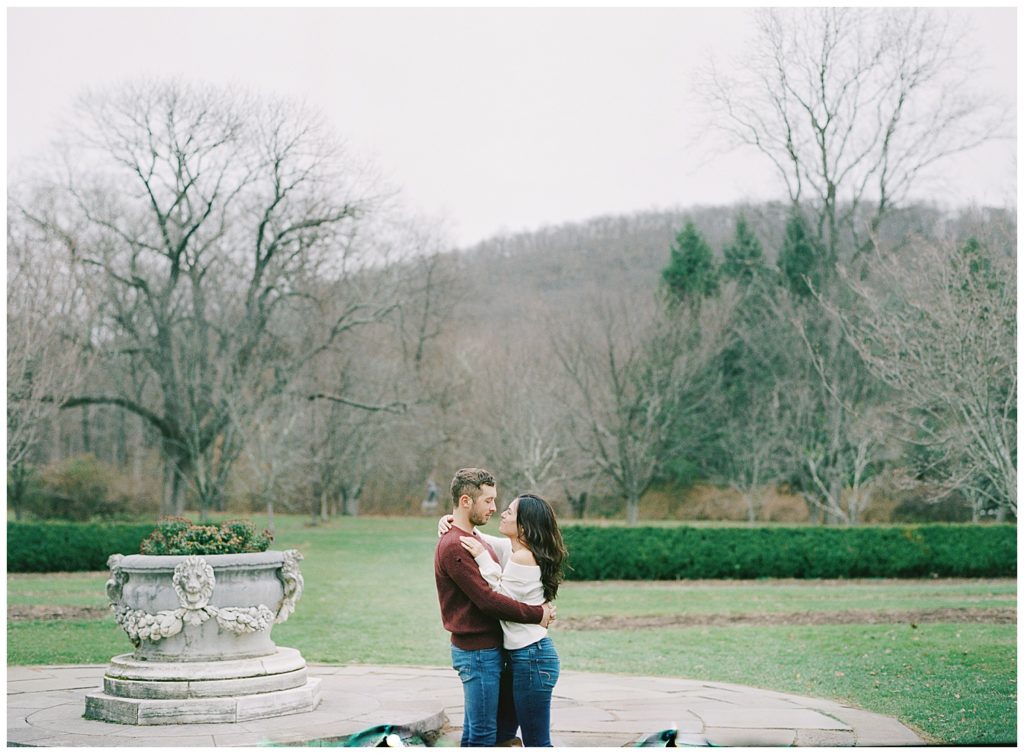 landscape photo of couple embracing in New Jersey Botanical garden for their autumn engagement by film photographer AGS Photo Art