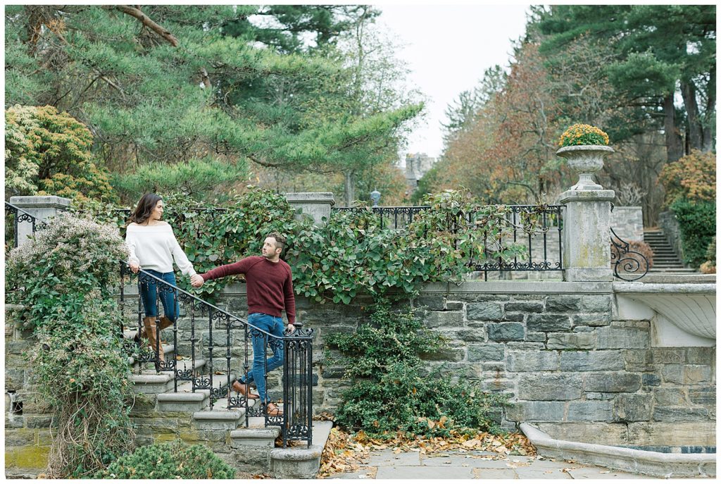 couple hand in hand walking down a stone staircase in New Jersey Botanical Garden for their engagement portraits by film photographer AGS Photo Art