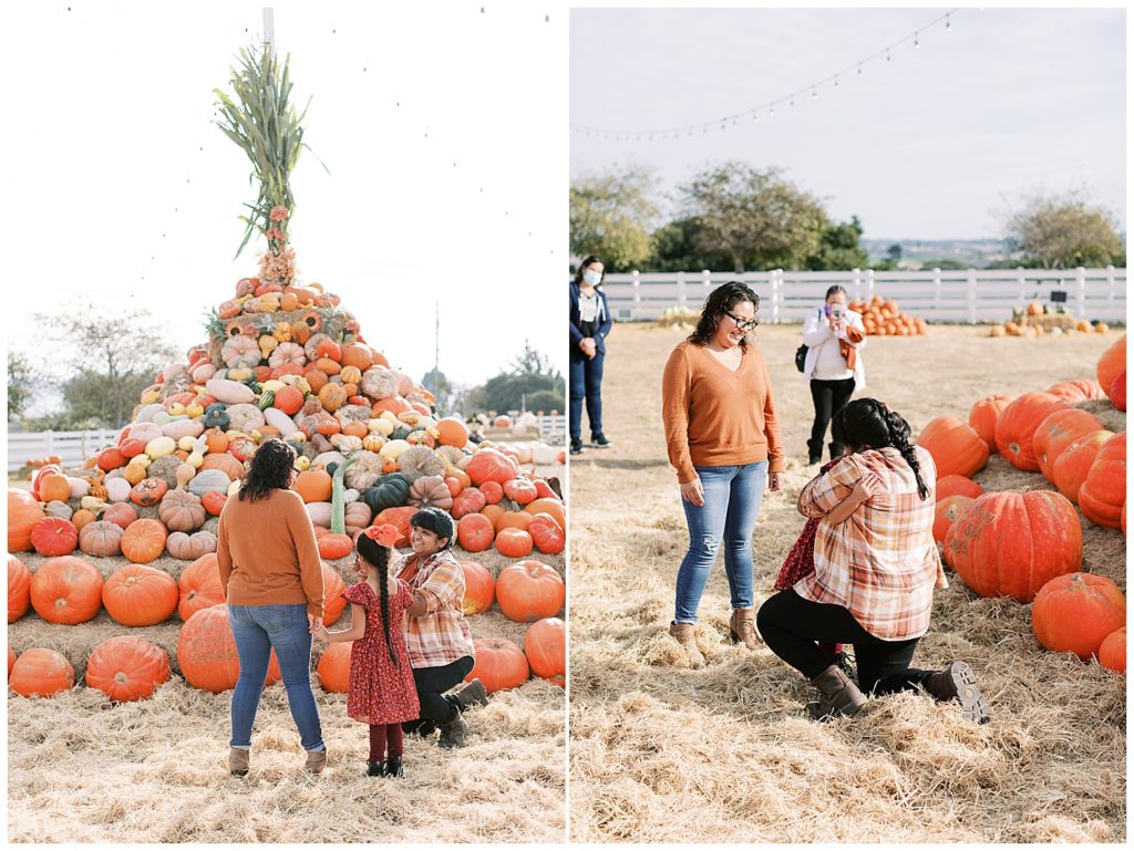 couple and daughter at the foot of a pumpkin pile for the women's surprise proposal by film photographer AGS Photo Art