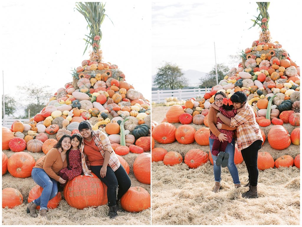 couple and daughter playing at the foot of a pumpkin mountain at Bochard Farms during their proposal