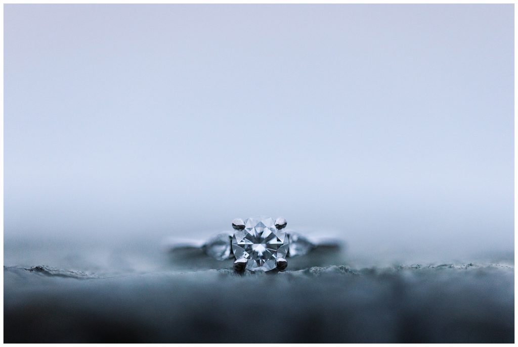 soft focus photo of Big Sur Engagement diamond ring on a rock by film photographer AGS Photo Art