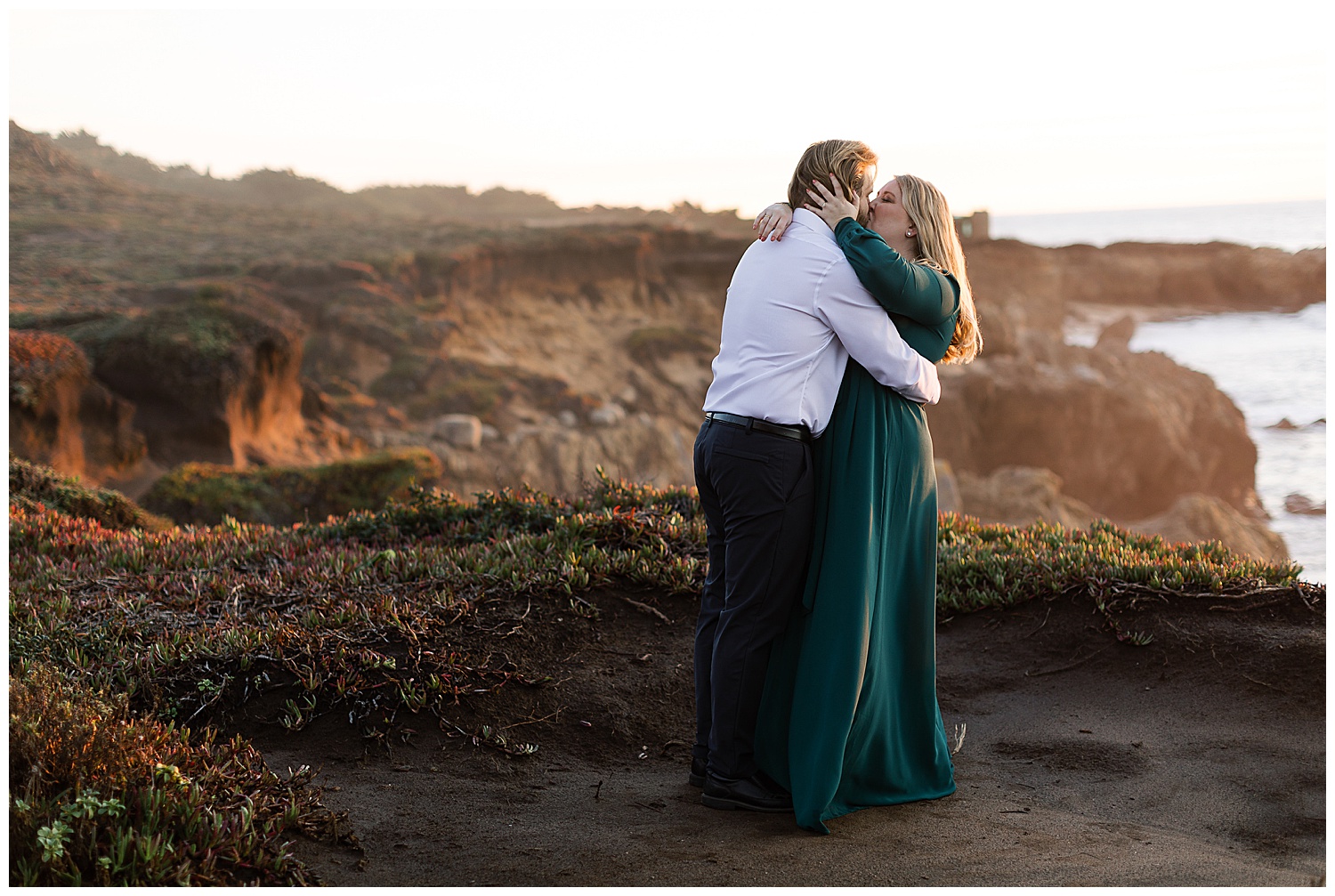 couple sharing a kiss at sunset with the Big Sur CA cliffside and ocean behind them by film photographer AGS Photo Art