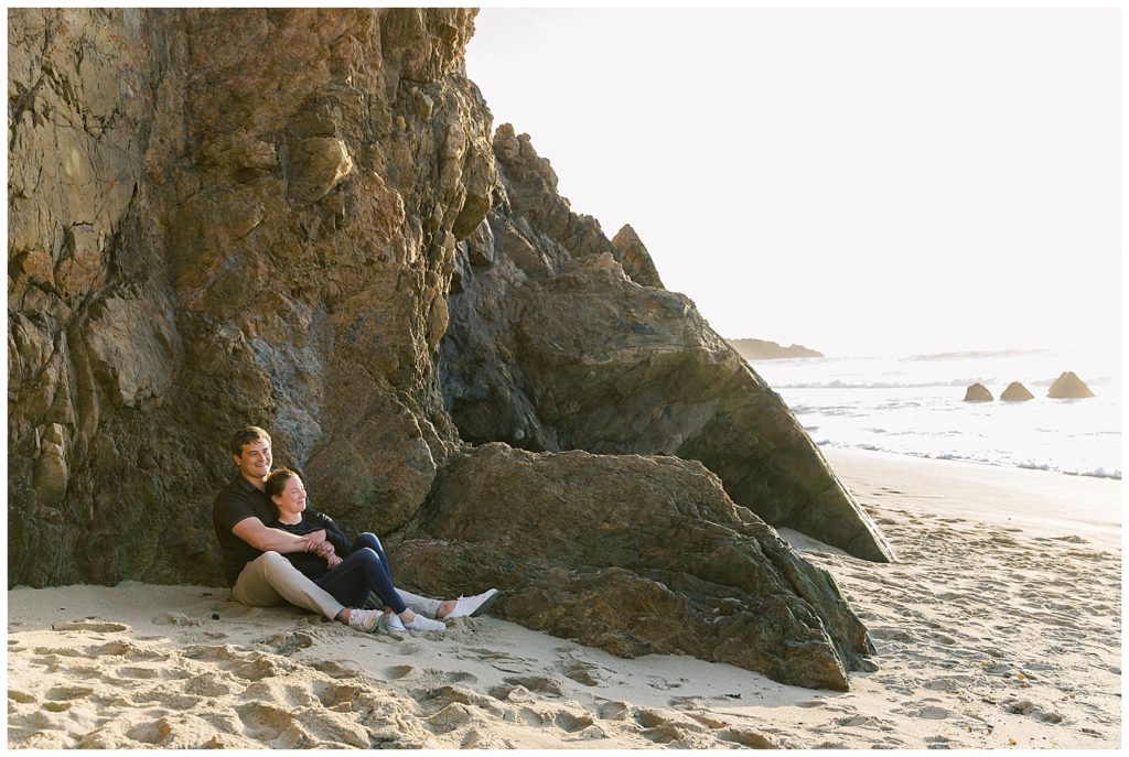couple laying in the sand in Big Sur for their proposal by film photographer AGS Photo Art
