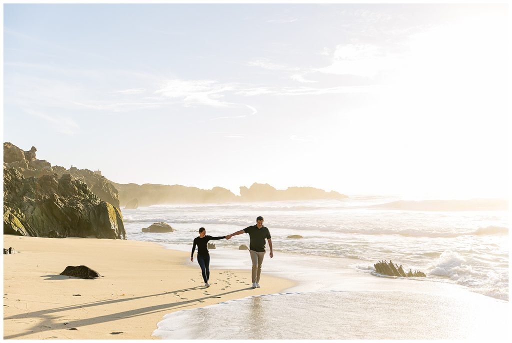 couple holding hands walking down the beach in Big Sur, CA by film photographer AGS Photo Art