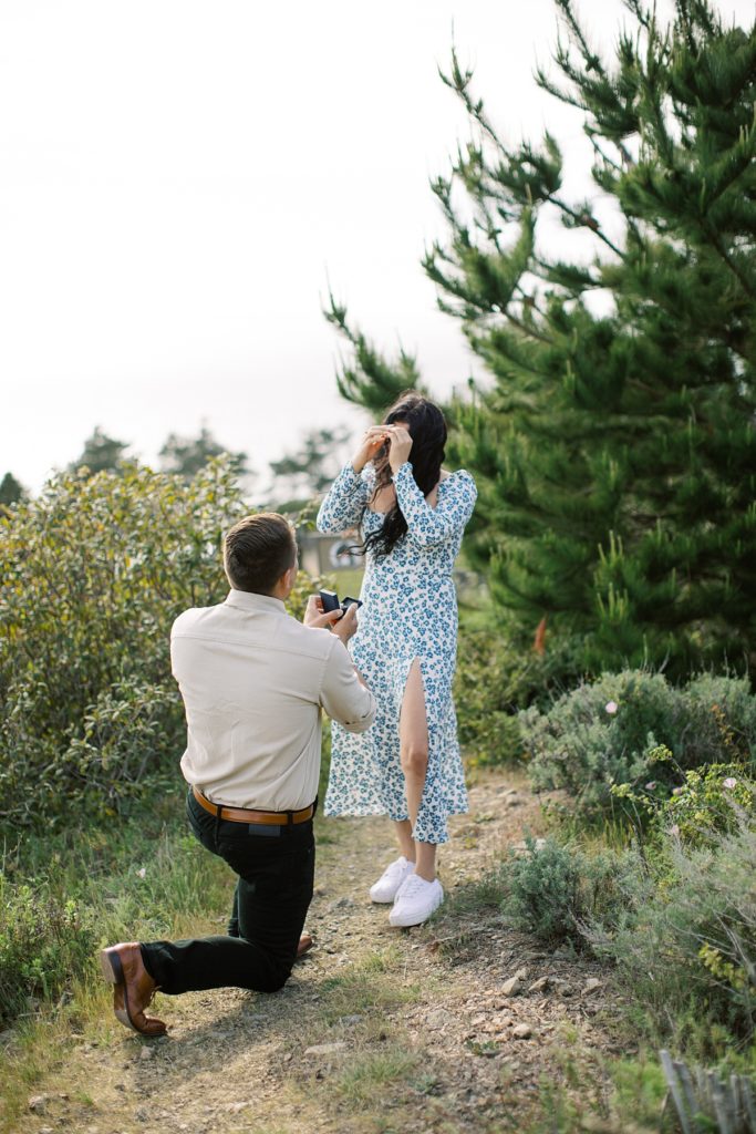 man proposing to his fiancée at Treebones Resort in Big Sur