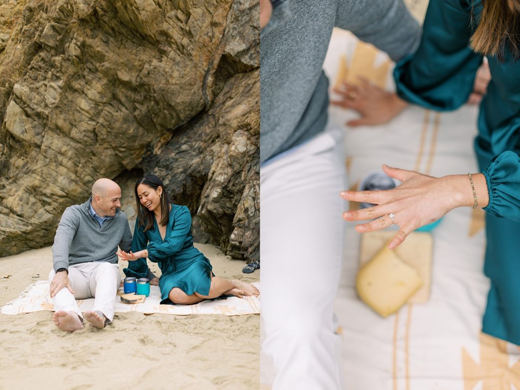 Big Sur surprise proposal at Garrapata Beach; couple enjoying a picnic on the sand; focused shot of the ring on the fiancée's hand by film photographer AGS Photo Art