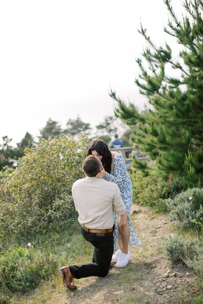 couple sharing a kiss during their Treebones Big Sur Surprise Proposal