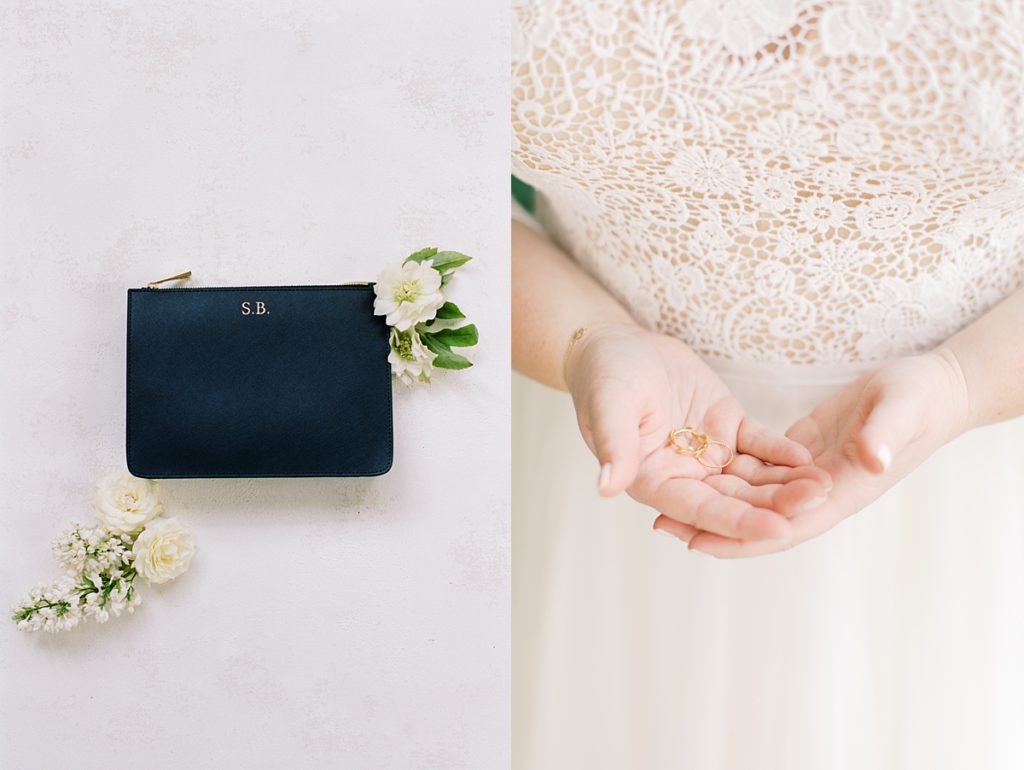 bride's clutch with her initials engraved onto it surrounded by white flowers; portrait of the bride's hands holding her wedding rings by film photographer AGS Photo Art