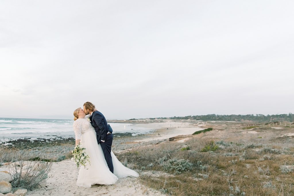 groom dipping back his bride for a kiss during their intimate wedding at Pebble Beach
