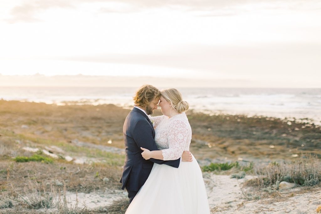 couple touching their foreheads together during their intimate private wedding at Pebble Beach