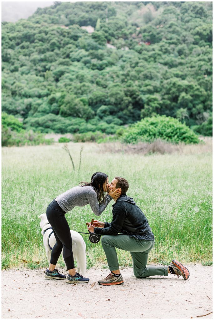 couple sharing a kiss after popping the question